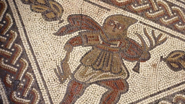 Close up of the mosaic in the Dining Room at Chedworth Roman Villa, showing the figure 'Winter' wearing a hooded cloak and holing a dead hare and a leafless branch, Gloucestershire
