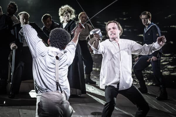 Two men in white shirts duel with swords, with players in Edwardian dress in the background.
