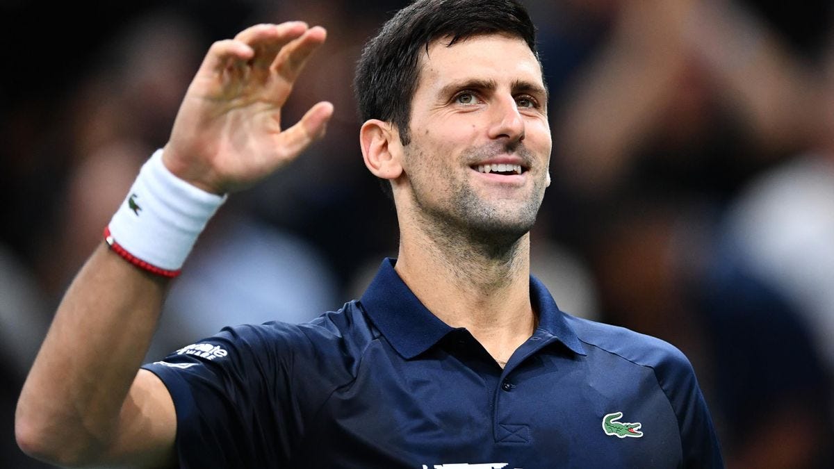 Novak Djokovic smiles on the court