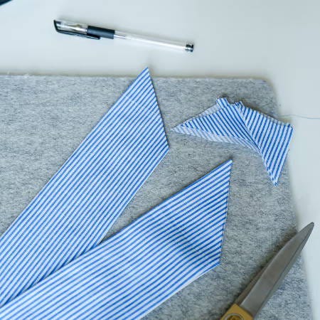 two edges of a fabric strip cut as a triangle two edges of a fabric strip cut as a triangle