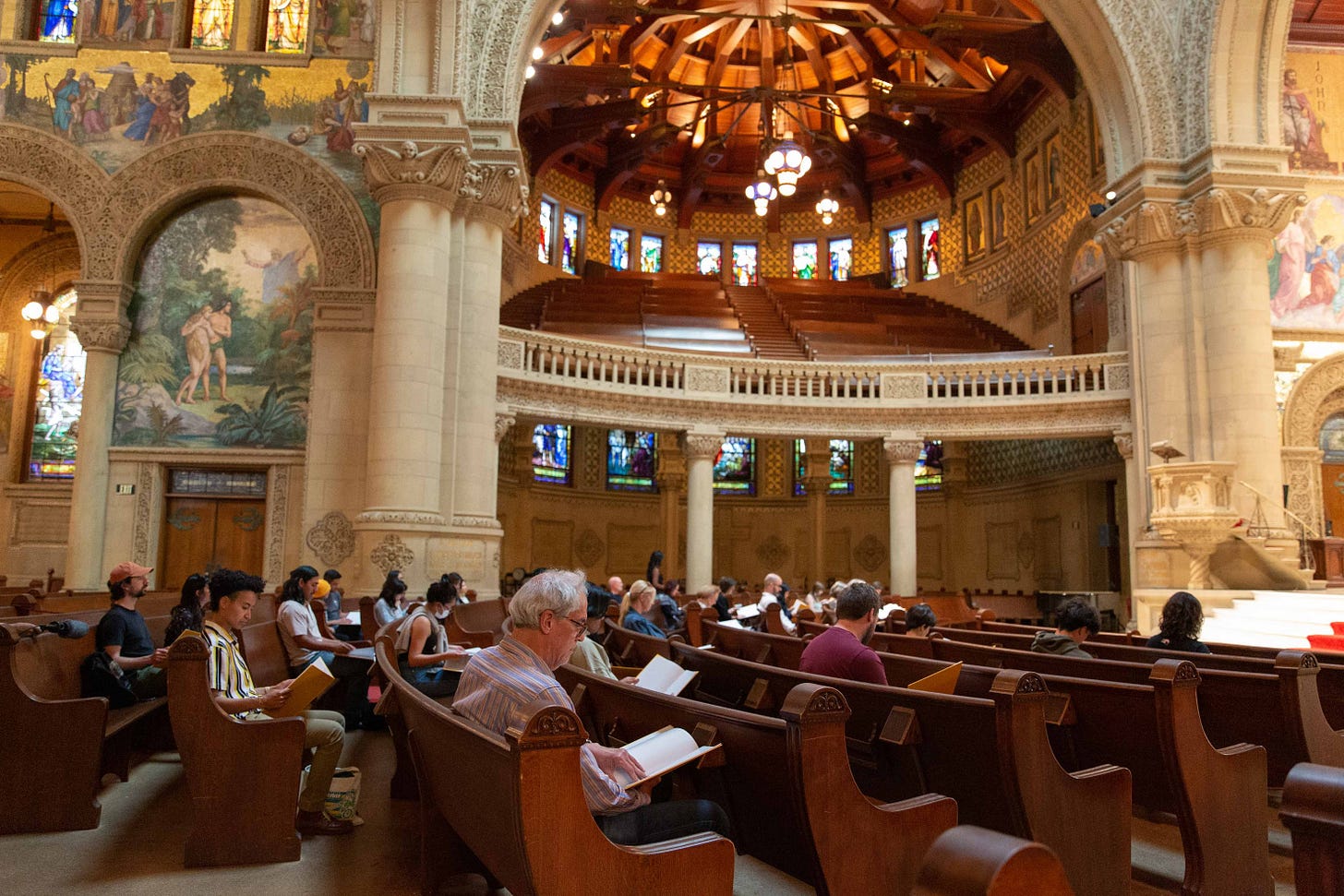 Attendees of The Gift at Stanford Memorial Church read the text while seated in the pews.