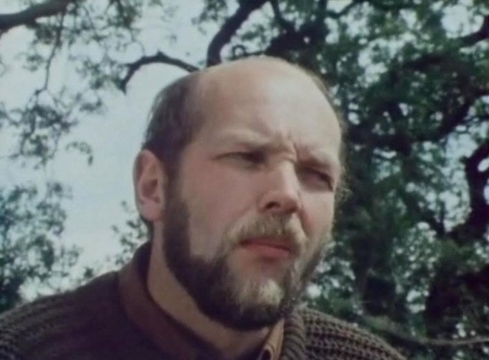 Man with perturbed look on his face in a knitted jumper in the woods Man with perturbed look on his face in a knitted jumper in the woods