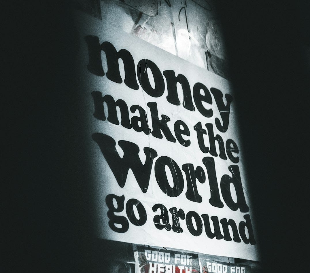 a sign that says money make the world go around a sign that says money make the world go around