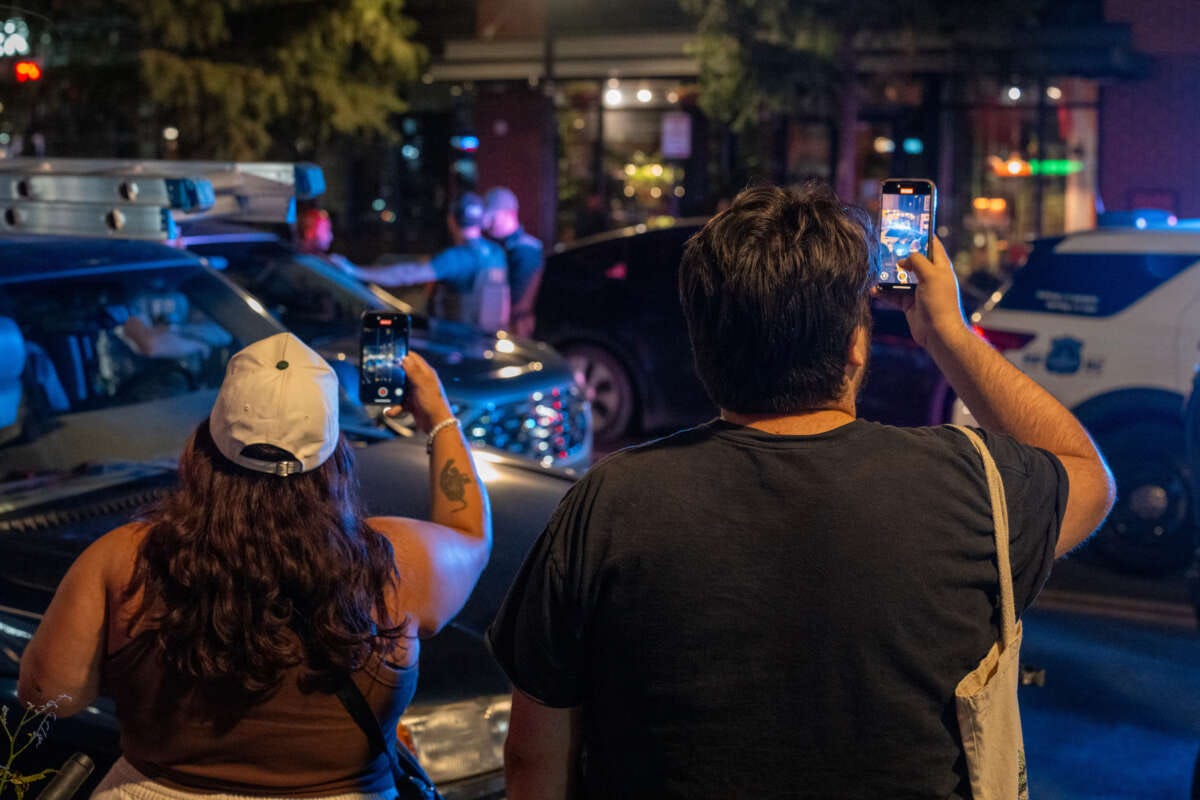 Residents record a Metropolitan Police officer in Washington, D.C.