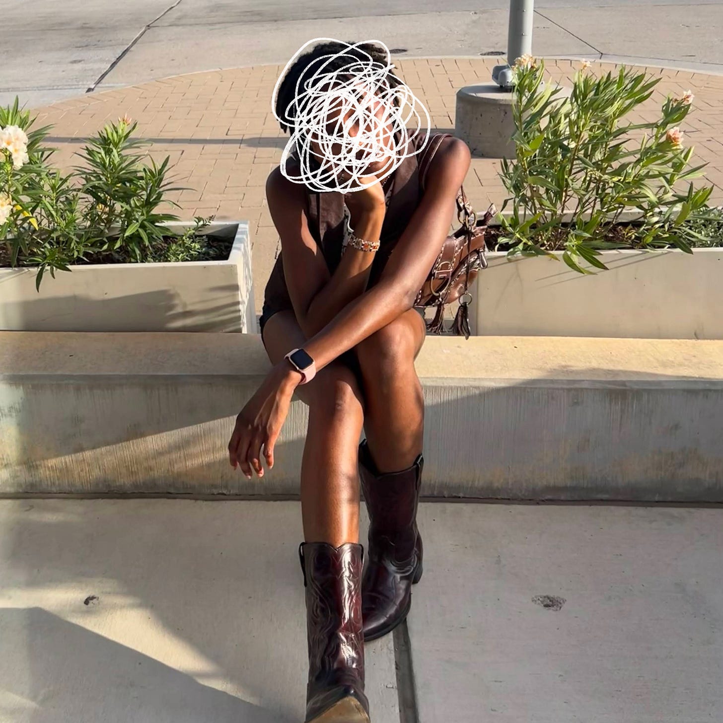 an image of me sitting down on a concrete crub with cowboy boots. my face is scribbled out and my elbows are on my knees, one hand holding my head and the other across the opposite knee.