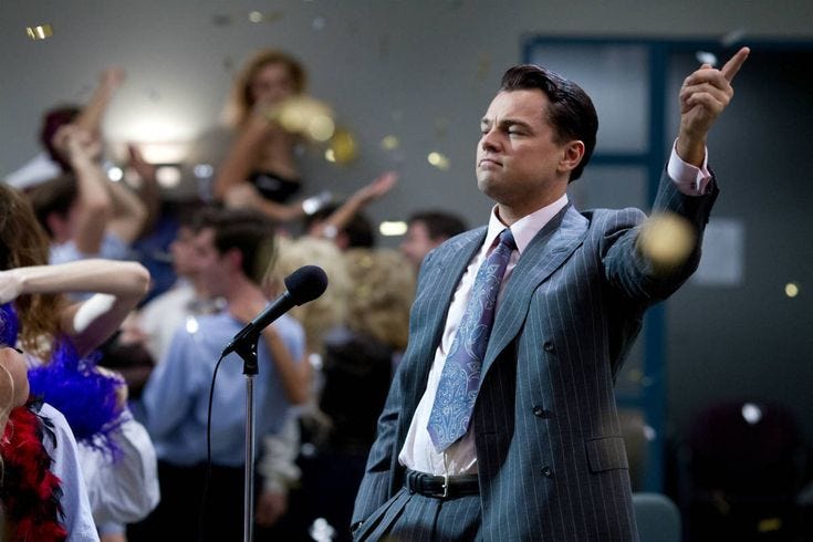 This may contain: a man standing in front of a microphone with confetti falling from his hands