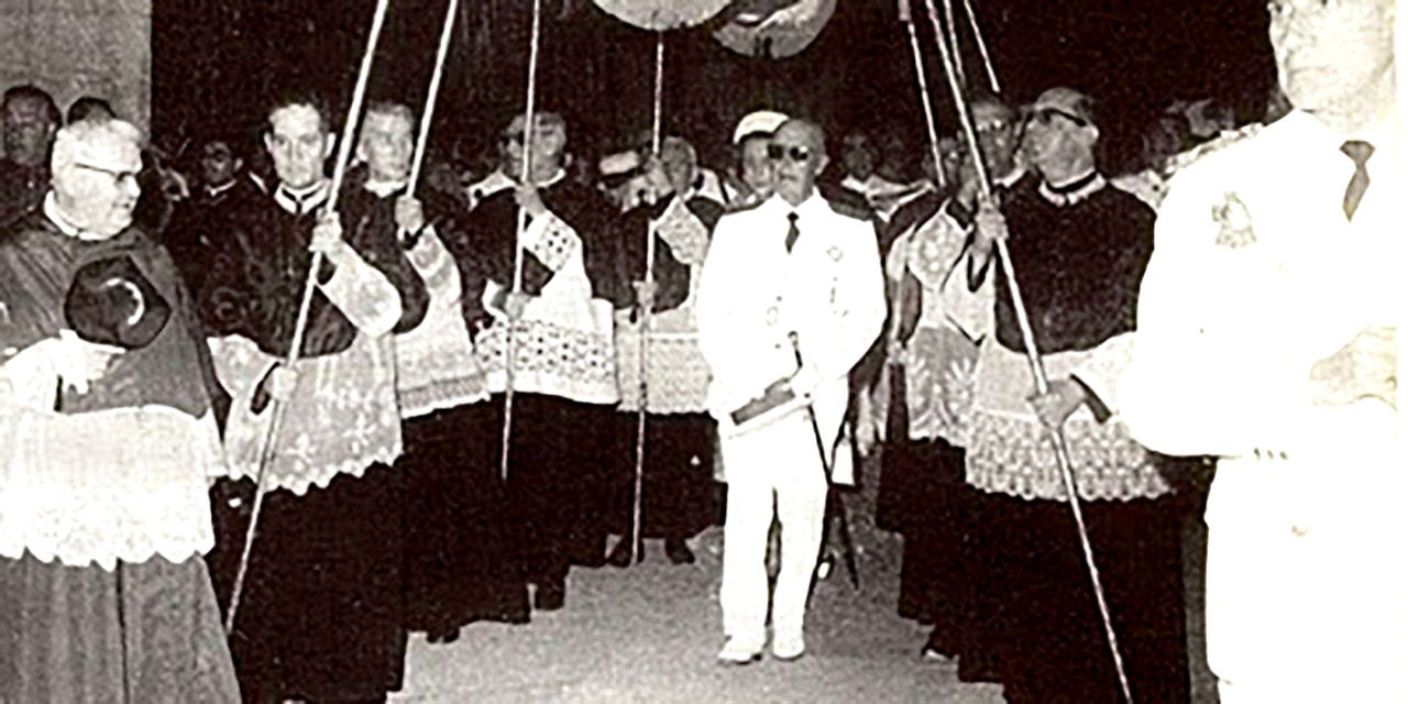 Franco in white military uniform receives ceremonial blessing under a palio canopy, likely during the 1939 Madrid Victory Parade celebrations that marked the Nationalist triumph in the Spanish Civil War. Franco in white military uniform receives ceremonial blessing under a palio canopy, likely during the 1939 Madrid Victory Parade celebrations that marked the Nationalist triumph in the Spanish Civil War.