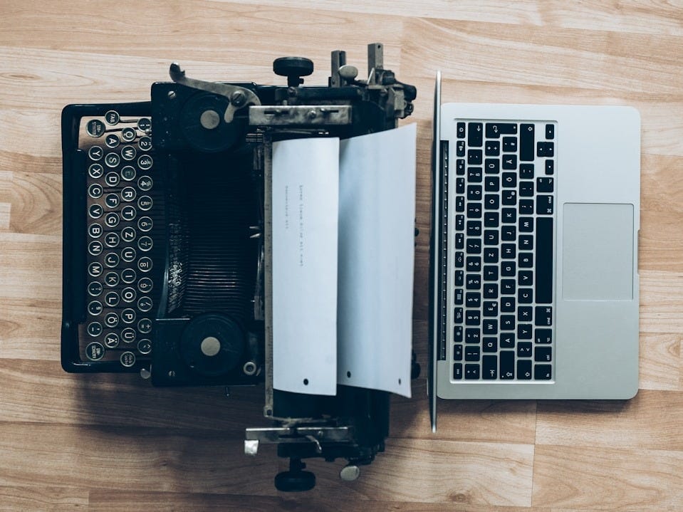 gray typewriter and MacBook