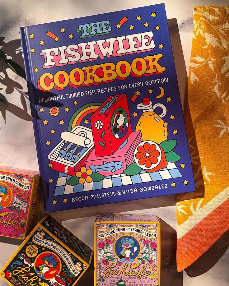 This may contain: the fishwife cookbook is on display in front of other colorful dishes and napkins