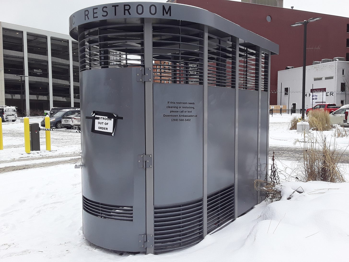 The single existing open-to-the-public Portland Loo in Kalamazoo. It's located at 108 E. Water St., in the northwest corner of the Haymarket parking lot. A sign on the door reads "RESTROOM OUT OF ORDER". The sign has been there since at least Wednesday, January 17; likely a lot longer. Photograph taken on the afternoon of Thursday, January 18. The single existing open-to-the-public Portland Loo in Kalamazoo. It's located at 108 E. Water St., in the northwest corner of the Haymarket parking lot. A sign on the door reads "RESTROOM OUT OF ORDER". The sign has been there since at least Wednesday, January 17; likely a lot longer. Photograph taken on the afternoon of Thursday, January 18.