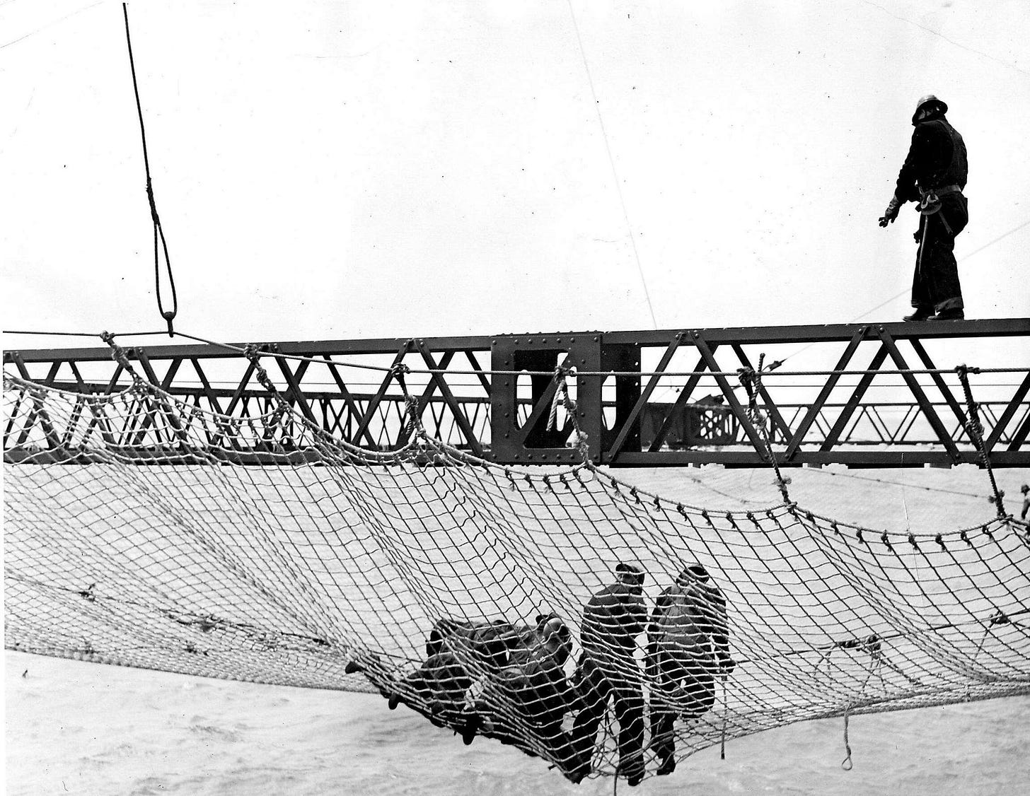 Workers installing a safety net during the construction of the Golden Gate Bridge Workers installing a safety net during the construction of the Golden Gate Bridge