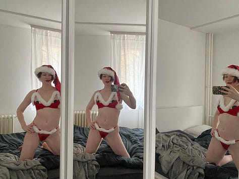 Stoya in soft green shirt and shorts in front of Pachira tree surrounded by grey Christmas creatures, Stoya in red and white Santa inspired lingerie in three sided mirror, Stoya with forest green rhinestoned Christmas nails.