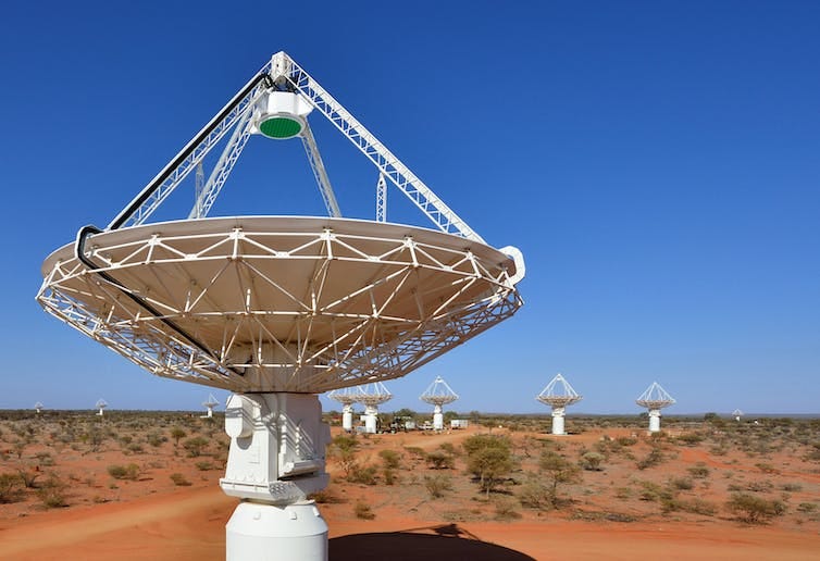 Several of the ASKAP radio telescopes in daylight pointing skyward Several of the ASKAP radio telescopes in daylight pointing skyward
