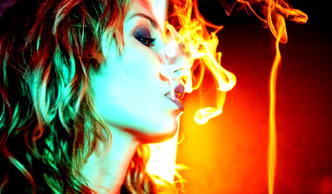 a woman smoking a cigarette in the dark a woman smoking a cigarette in the dark