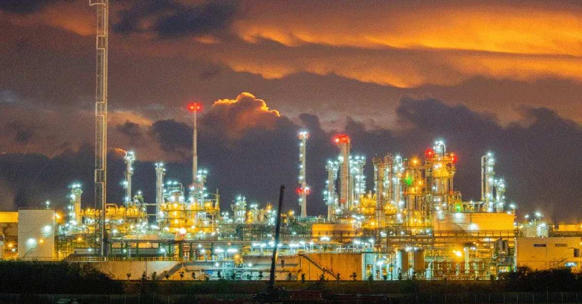 A wide editorial photograph of a cryogenic helium processing facility at dawn, illustrating the physical infrastructure of the Qatari helium supply chain at the centre of Part 2's analysis.