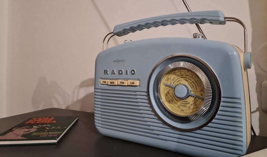 a radio sitting on top of a table next to a book
