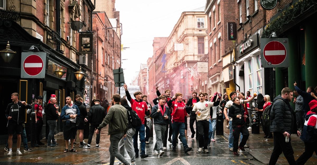 Photo: Thet Tun Aung / Pexels A vibrant street scene of football fans celebrating in Liverpool, England.