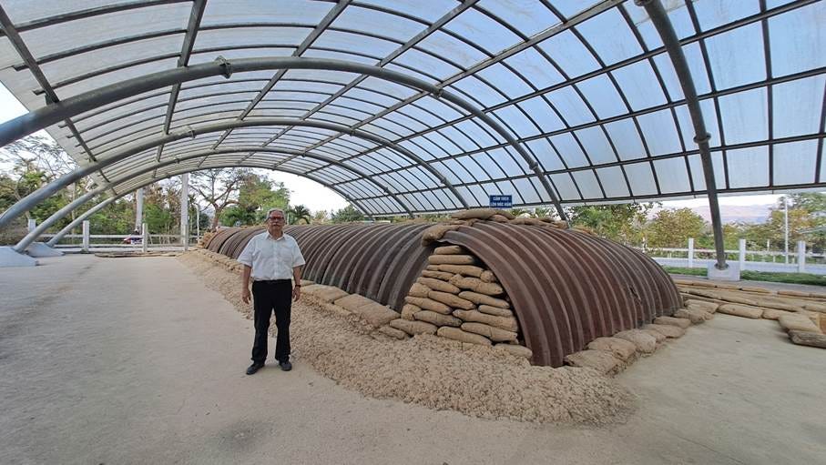 A person standing in front of a metal structure

AI-generated content may be incorrect.