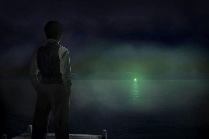 This may contain: a man standing on a dock looking at the water with a green light in the distance
