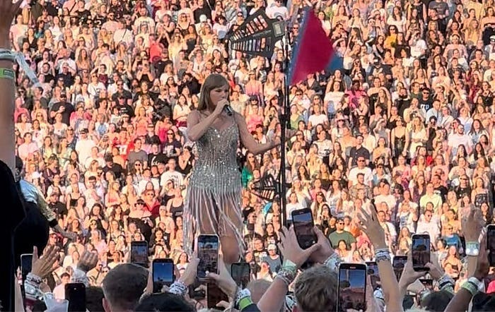 Taylor Swift in a gold sparkly outfit.