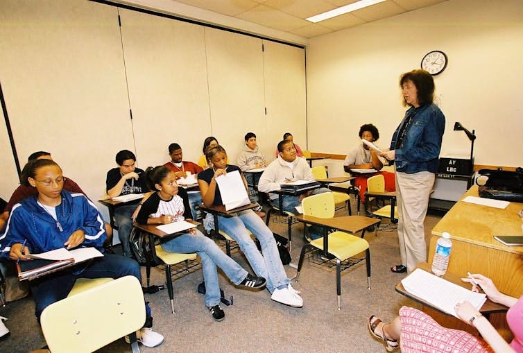 Photos of small college classroom with teacher and students Photos of small college classroom with teacher and students