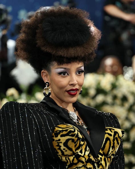 Collage featuring Cardi B, Issa Rae, Angela Bassett, Colin Kaepernick, Doja Cat, Lauryn Hill, and Doechii wearing afro hairstyles at the 2025 Met Gala.