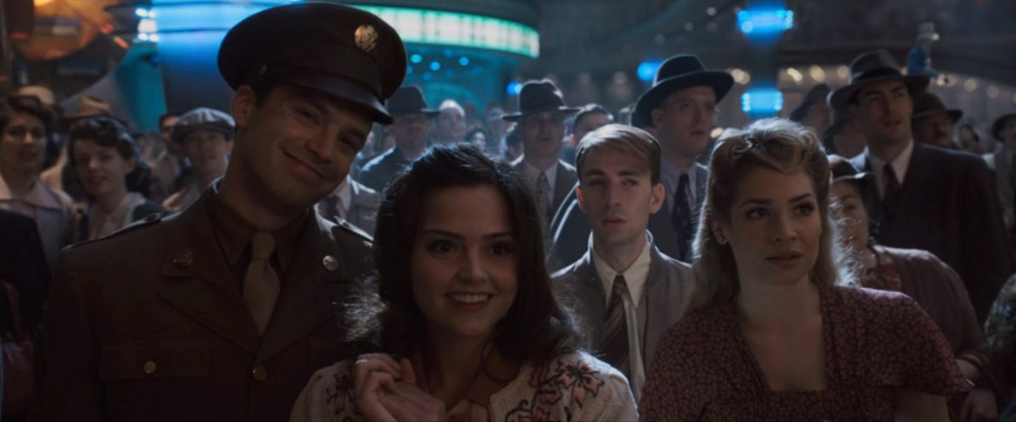 Bucky in uniform smiling as a girl leans into him.