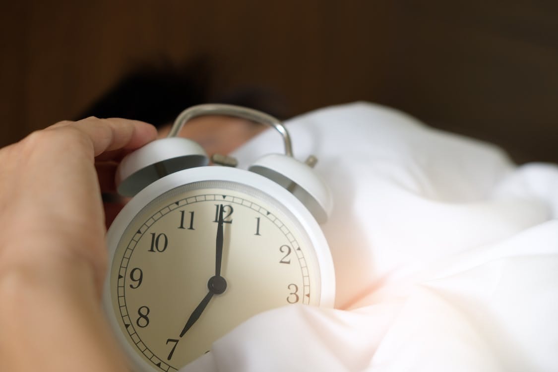 Free Photo of Person Holding Alarm Clock Stock Photo Free Photo of Person Holding Alarm Clock Stock Photo