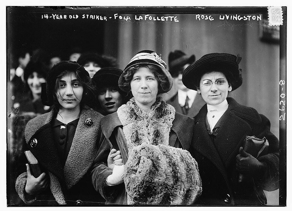 Black and white photo of three women, facing the camera. The one in the middle has light, pale skin and curly hair and is wearing a mink coat. The one on the right short black hair and brownish skin and is wearing a coat. The one on the right is wearing a black hat and black coat with light, pale skin and glasses. Black and white photo of three women, facing the camera. The one in the middle has light, pale skin and curly hair and is wearing a mink coat. The one on the right short black hair and brownish skin and is wearing a coat. The one on the right is wearing a black hat and black coat with light, pale skin and glasses.