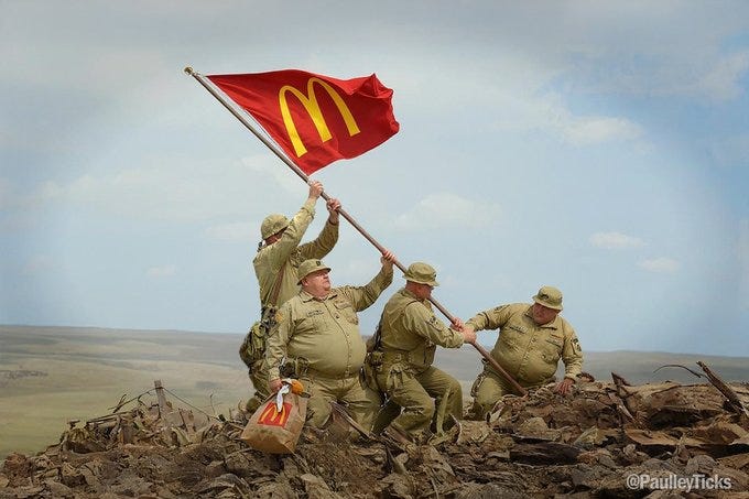Four soldiers in khaki military uniforms raise a large red flag with the golden McDonalds arches emblem on a rocky debris-covered hilltop under a clear sky one soldier holds a white McDonalds bag the scene parodies a historical flag-raising moment with fast food elements integrated into the military attire and setting watermarks from PaulleyTicks visible at bottom corners Four soldiers in khaki military uniforms raise a large red flag with the golden McDonalds arches emblem on a rocky debris-covered hilltop under a clear sky one soldier holds a white McDonalds bag the scene parodies a historical flag-raising moment with fast food elements integrated into the military attire and setting watermarks from PaulleyTicks visible at bottom corners