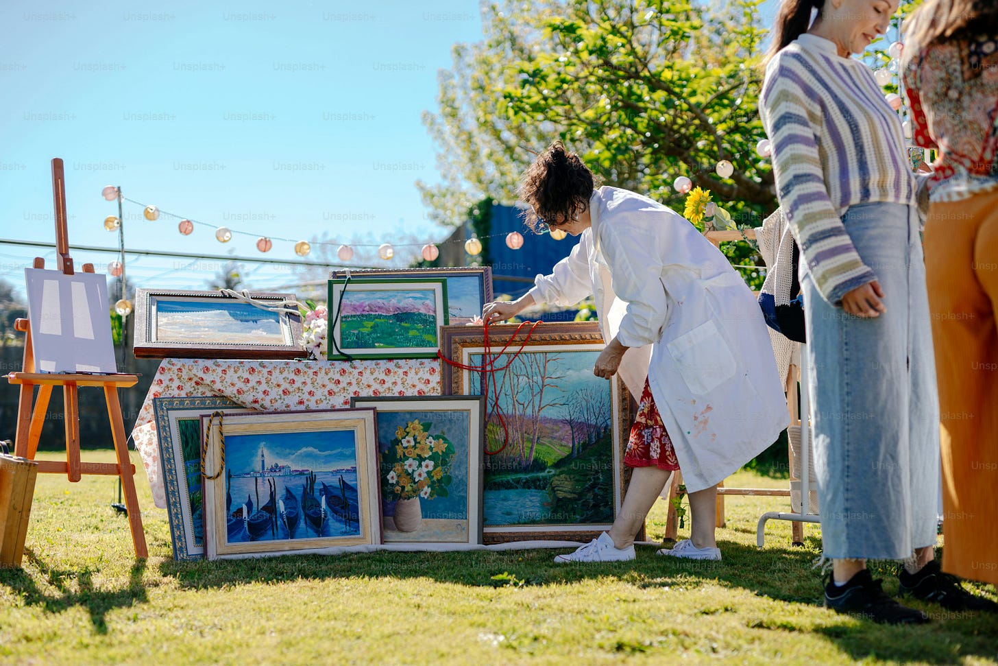 a group of people standing around a table with pictures on it