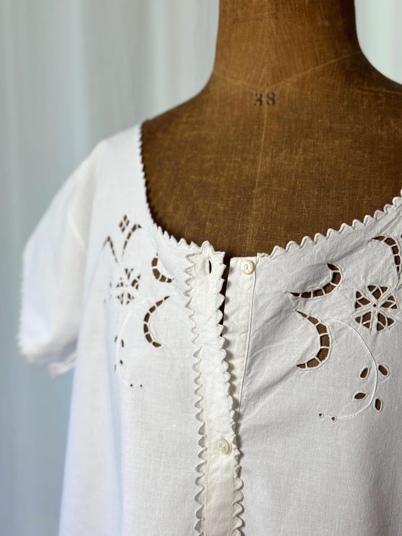 Antique Italian nightdress from the 1910s, heirloom-quality and entirely handmade from a crisp linen and cotton blend. cutwork embroidery and luminous mother-of-pearl buttons. Flowy silhouette, drapes beautifully on the body. A romantic vintage nightgown or graceful summer dress. Still perfectly wearable. A rare early 20th-century Italian textile, ideal as a poetic “something old” for a bride or a meaningful gift for vintage lovers. French Provence chic countryside. Victorian Edwardian dress