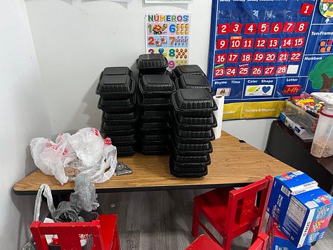 IMAGE 1: A white table with gray plastic bags full of dinner plates and safe sex kits. IMAGE 2: Stacks of black dinner plates and plastic bags on a wooden table. IMAGE 3: A green and yellow travel container full of safe sex kits. 