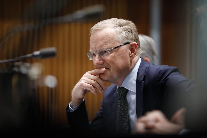 Philip Lowe giving evidence, resting his head on his hand. Philip Lowe giving evidence, resting his head on his hand.