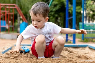 Image of Boy Playing in Sandbox