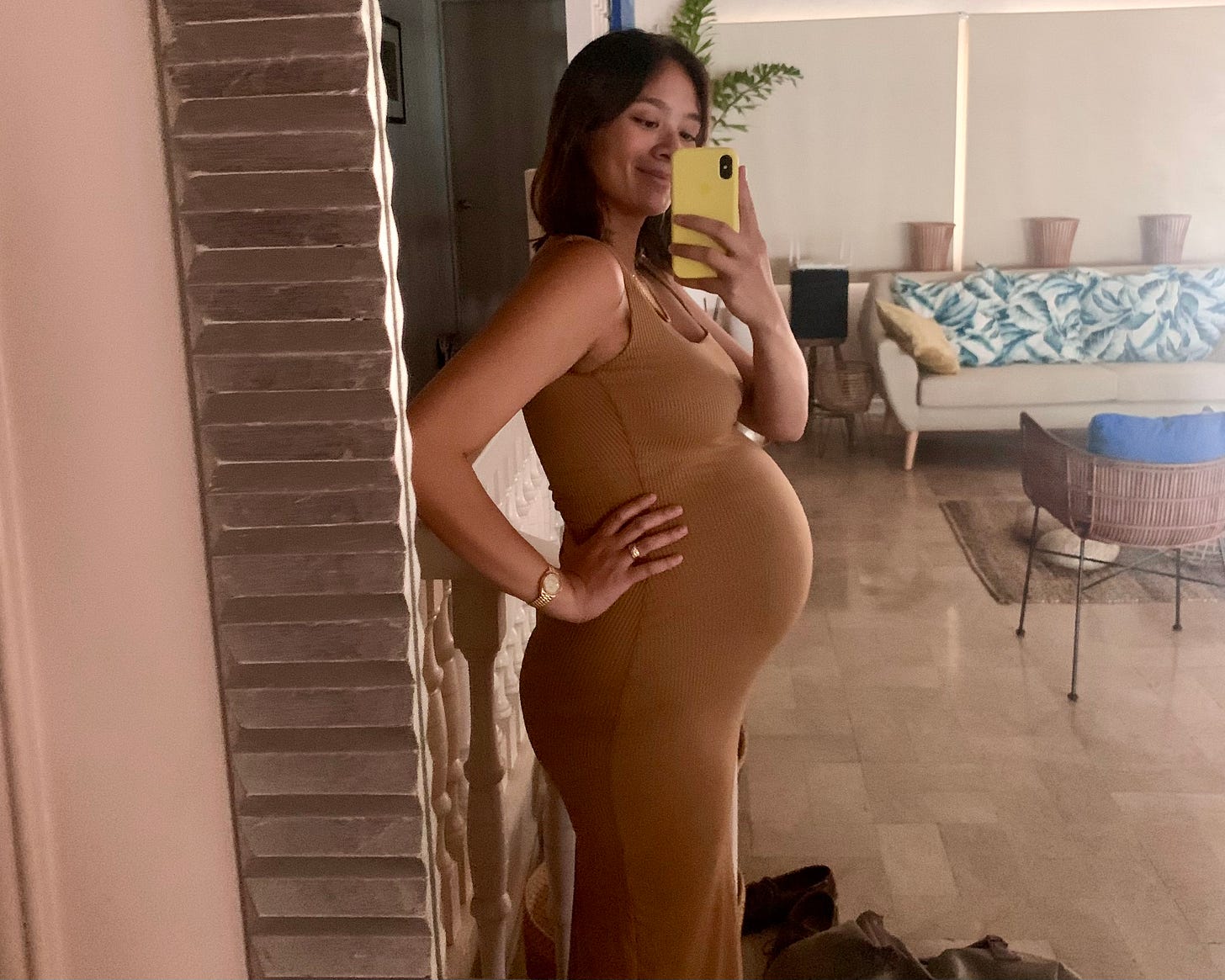 mirror selfie of a pregnant woman around 32 weeks pregnant
