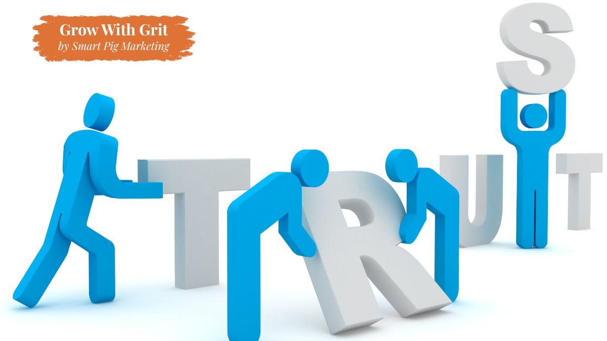 Simple illustration of blue human figures assembling the word "TRUST," with one figure placing the final letter into position. The image symbolizes trust being intentionally built over time through consistent actions. Grow With Grit by Smart Pig Marketing branding appears in the upper left corner.