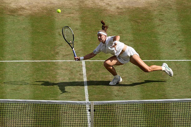 Karolina Muchova of Czechia slips and falls against Coco Gauff of United States during their Ladies' Singles semifinal match on day eleven of The...