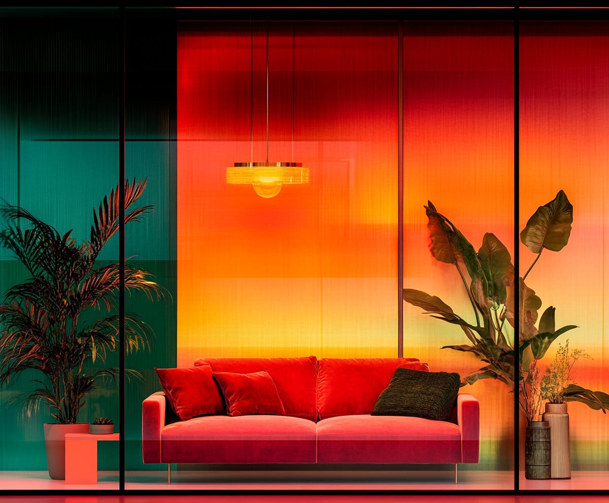 bold and colourful interior design concept with pink velvet sofa and a stunning sunset wallpaper backdrop, plush design interiors adelaide