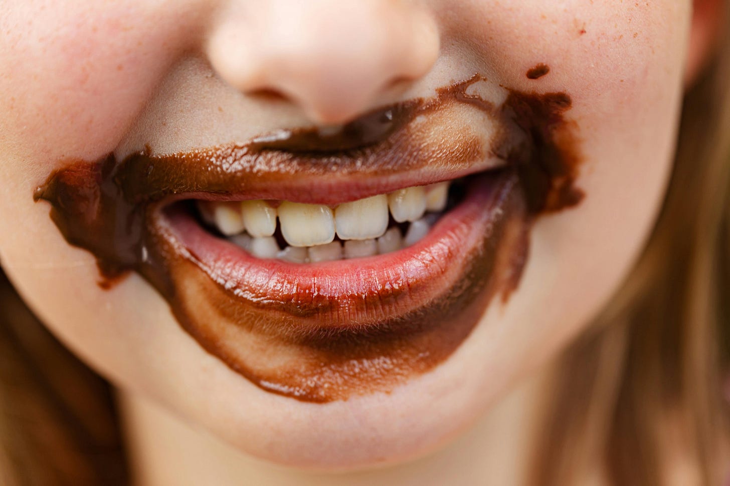Boy's face with chocolate around the lips