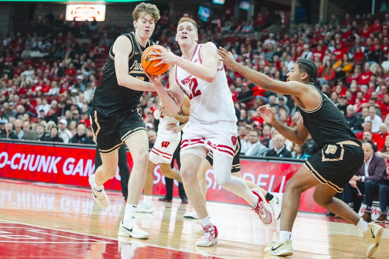 Rapp picks up his dribble while muscling through two defenders