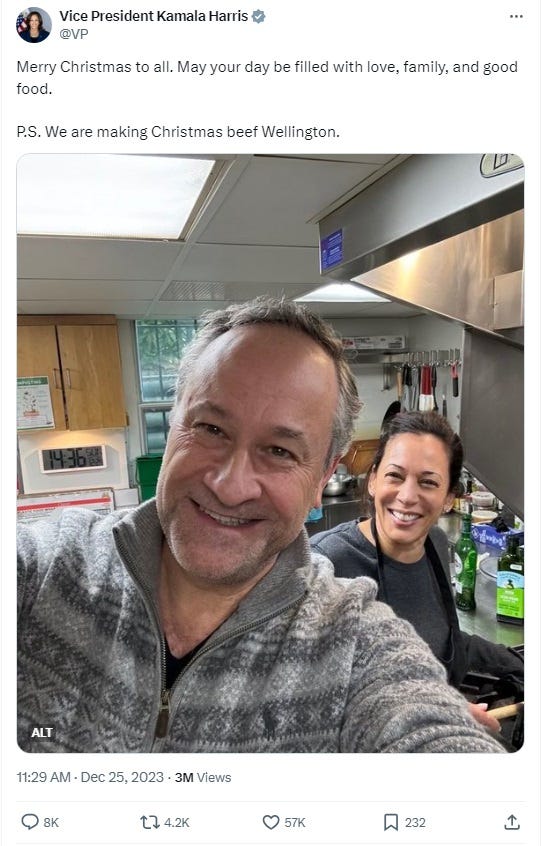 twitter screenshot: Text: 'Merry Christmas to all. May your day be filled with love, family, and good food.   P.S. We are making Christmas beef Wellington.'  Photo shows Doug Emhoff taking a selfie of himself and Harris in their kitchen, smiling, Emhoff has a fine fuzz of holiday not-bothering-to-shave stubble