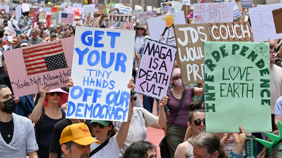 Signs that say "Get your tiny hands off democracy" "Maga id a death cult" "Love earth" Signs that say "Get your tiny hands off democracy" "Maga id a death cult" "Love earth"
