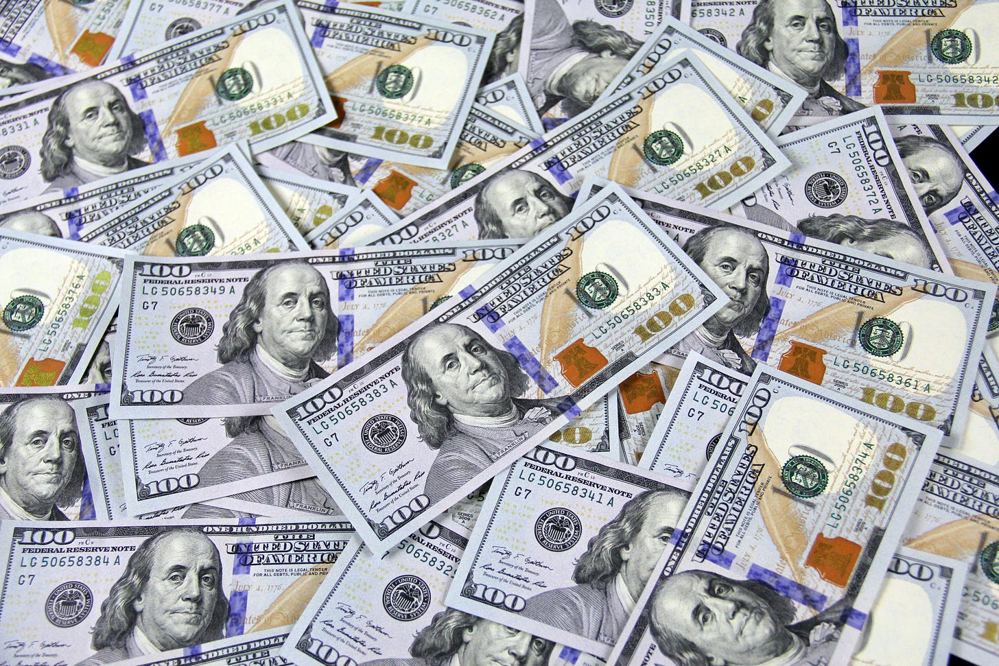 A bunch of $100 USD bills spread out