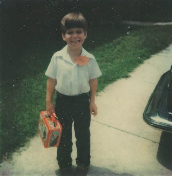Me holding my lunch box on the first day of kindergarten in 1979.