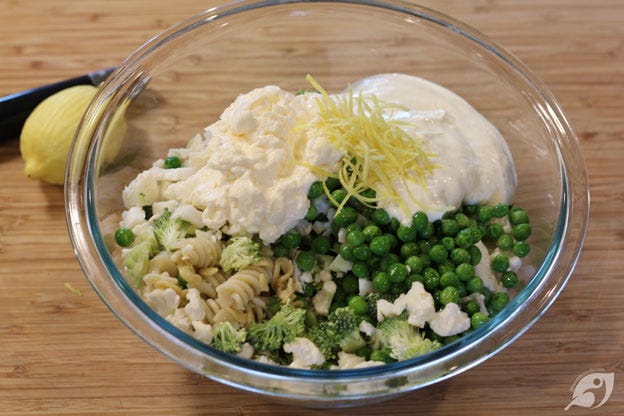 When thoroughly drained, place the pasta in a large bowl, add the broccoli, cauliflower, peas, prepared ranch dressing, mayonnaise, and lemon zest. When thoroughly drained, place the pasta in a large bowl, add the broccoli, cauliflower, peas, prepared ranch dressing, mayonnaise, and lemon zest.
