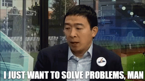 a man in a suit says " i just want to solve problems man " in front of a baseball field a man in a suit says " i just want to solve problems man " in front of a baseball field