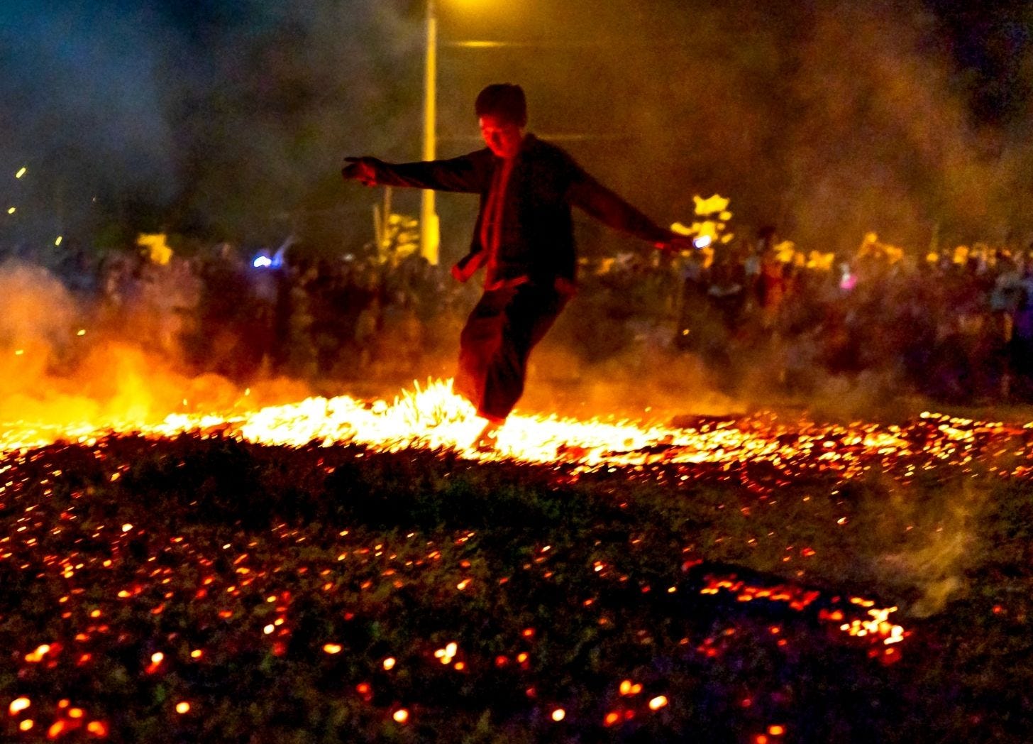 Free stock image (from Canva) of man walking across hot coals