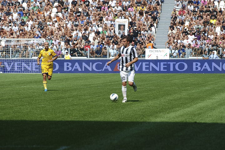 Juventus vs Parma, September 11, 2011: team huddle, player introductions, Antonio Conte coaching from the sideline, Pirlo and Del Piero in action, and Juventus players celebrating a goal during the opening match at Juventus Stadium.