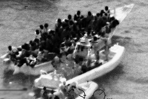 The US Coast Guard encounters a dangerously overloaded boat with 103 Haitians aboard. (US Coast Guard photo)